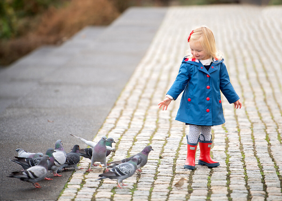 Family session of little girl wearing red rain boots