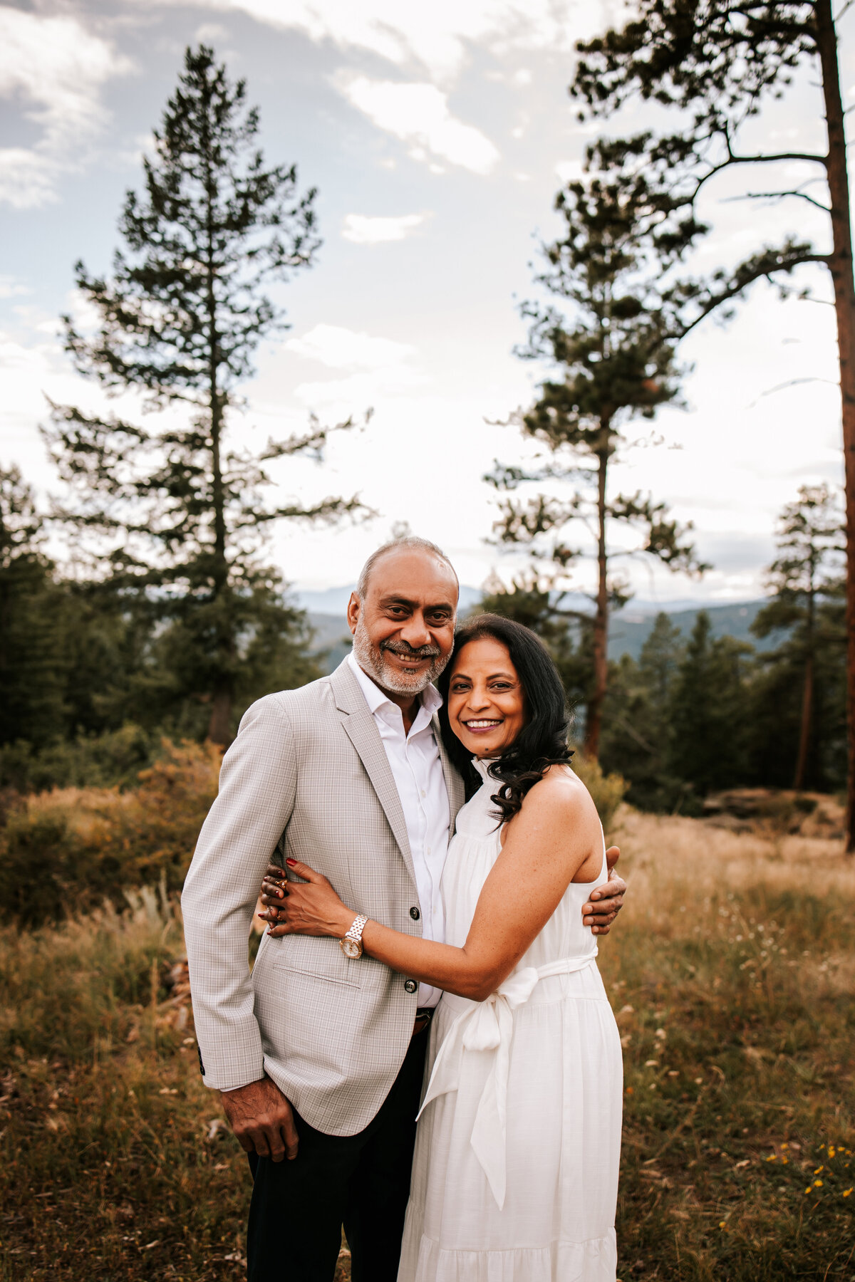 older colordo couple poses at mt falcon colorado for a couples session during summer