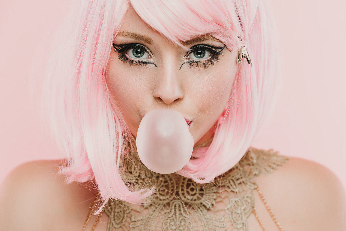 pink haired girl blowing bubble gum