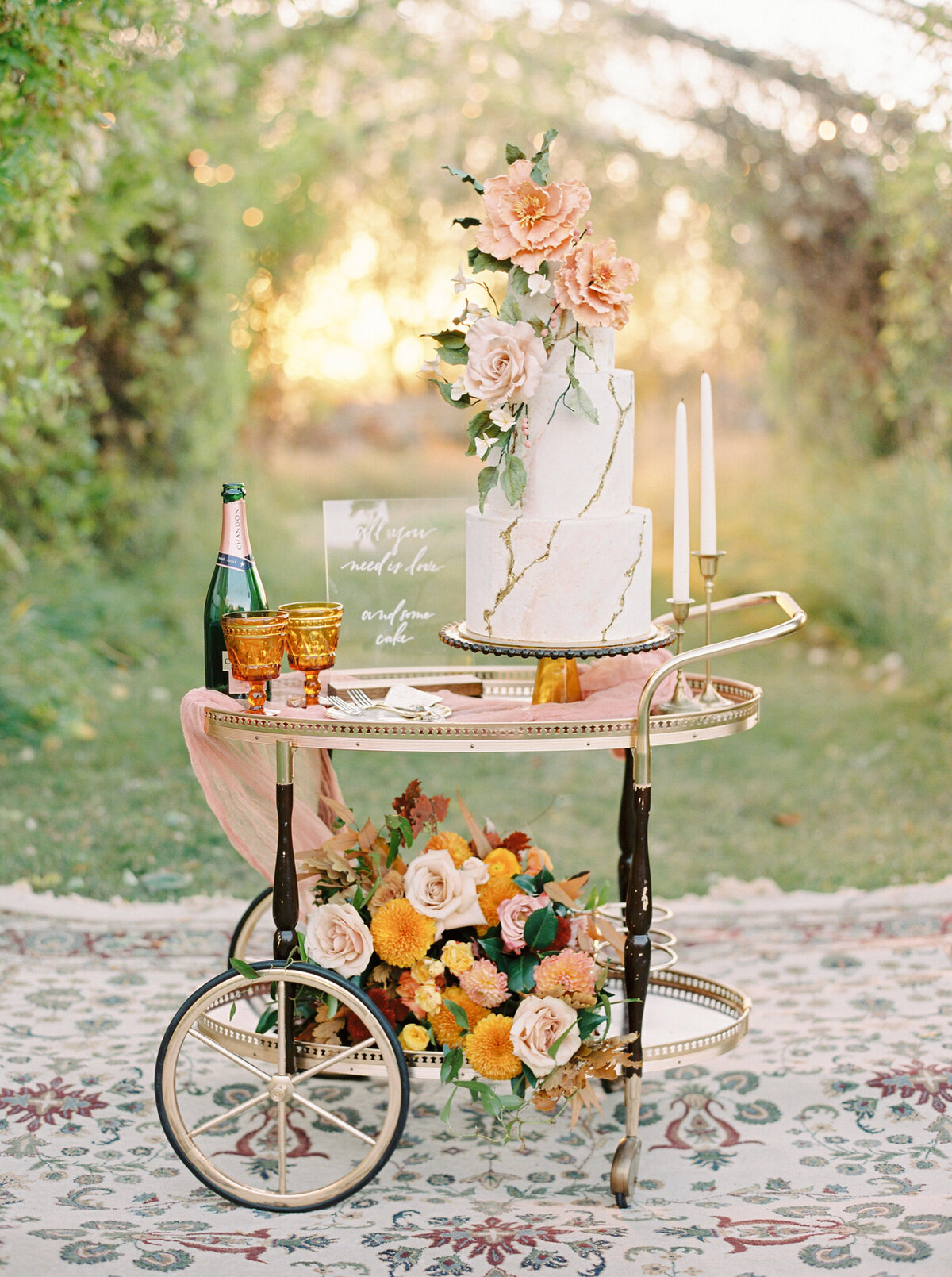Stunning and romantic wedding cake display on an elegant gold cart, captured by Justine Milton Photography, fine art  wedding photographer & videographer in Calgary Alberta. Featured on the Bronte Bride Vendor Guide.