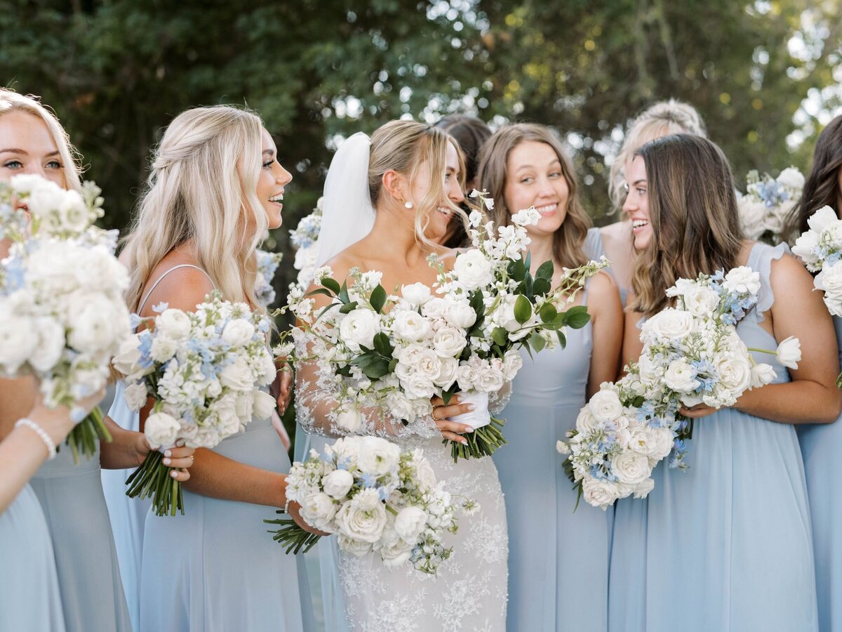 These flower arrangements are the star of this image as all the bridesmaids surround the bride.