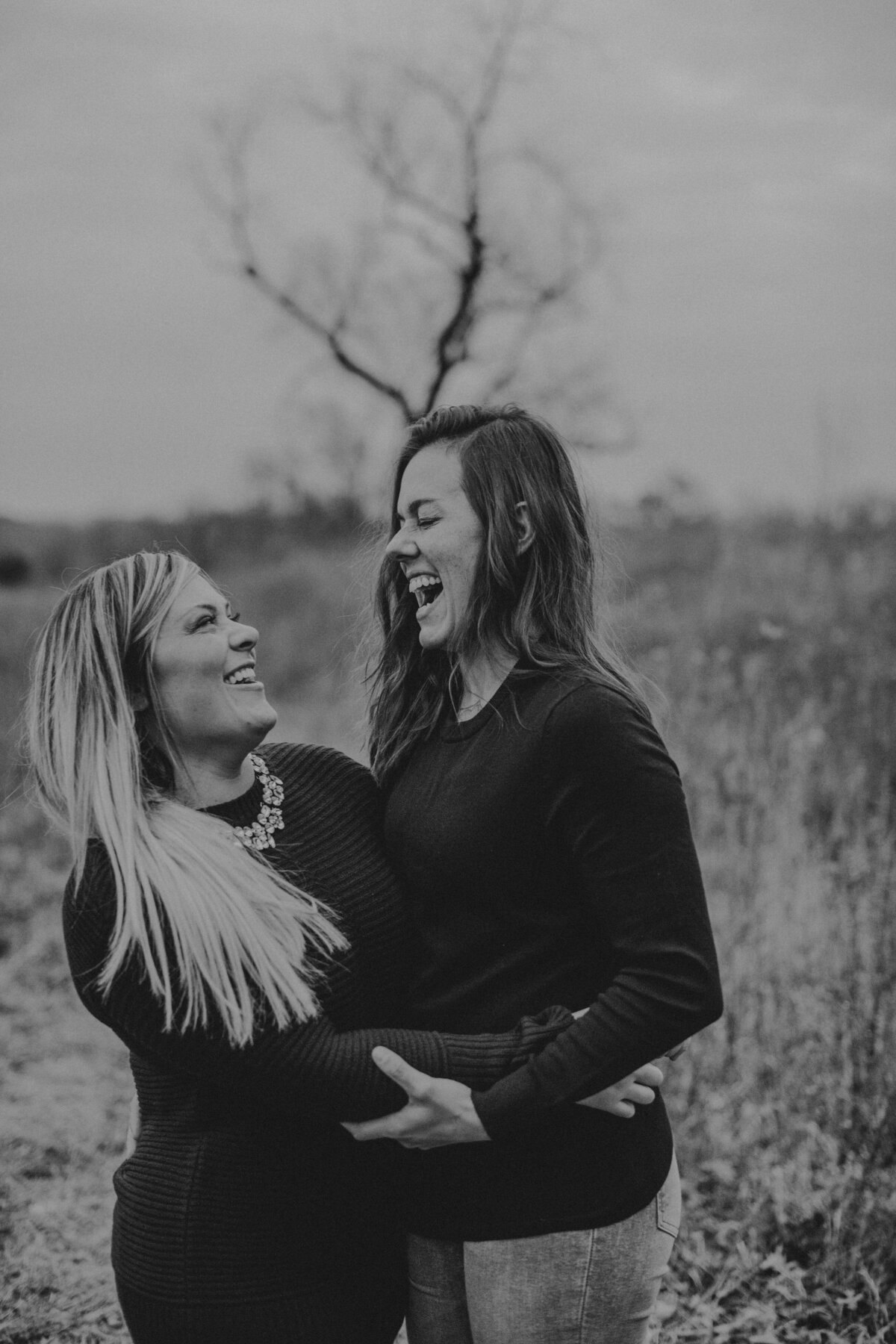 Two woman holding each other and laughing
