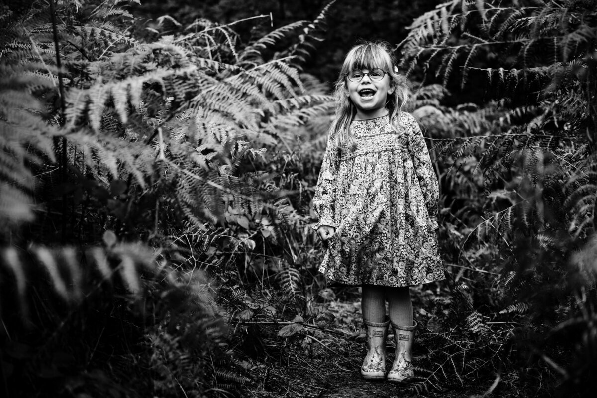 Little girl posing in the ferns at barnsdale woods