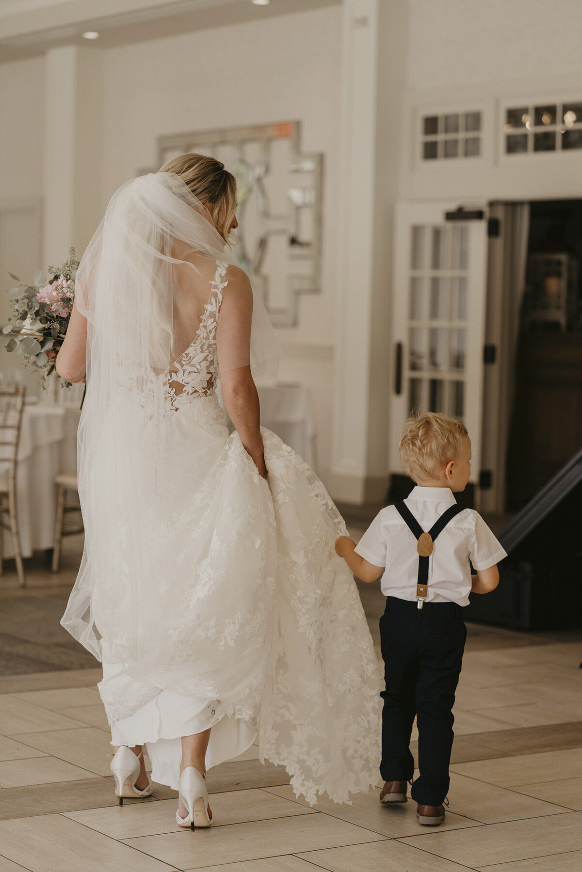 Bride walking with a ring bearer
