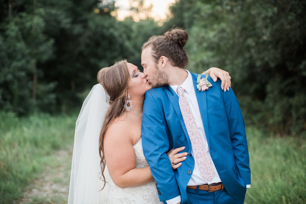 Wedding Photographer, couple kissing on a dirt road