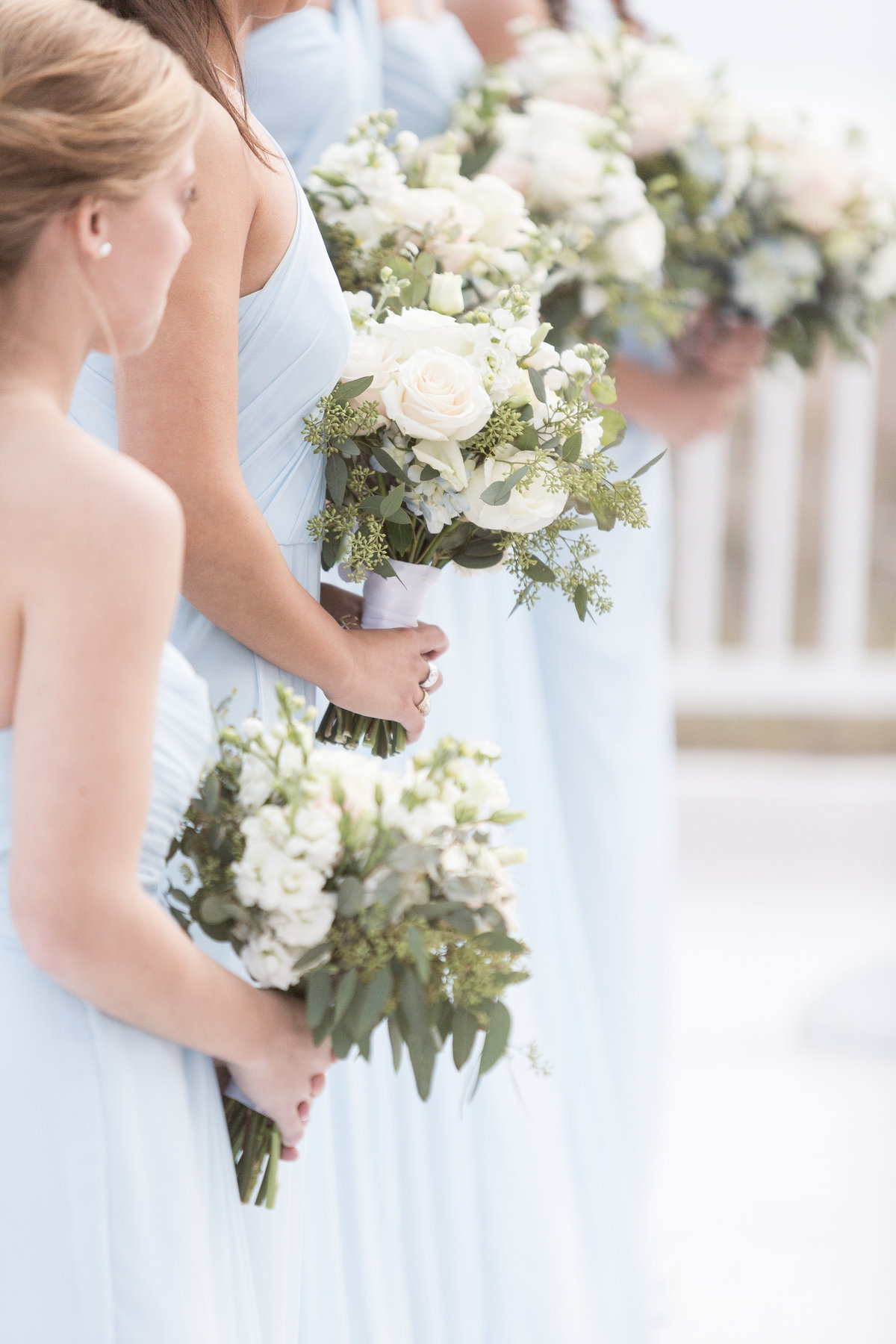 Bridesmaids holding their flowers during the wedding ceremony  at The Perdido Beach Resort in Orange Beach, Alabama.
