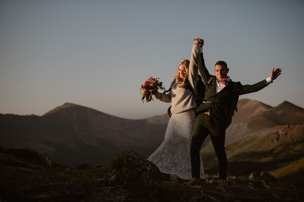 Couple celebrating on top of a mountain