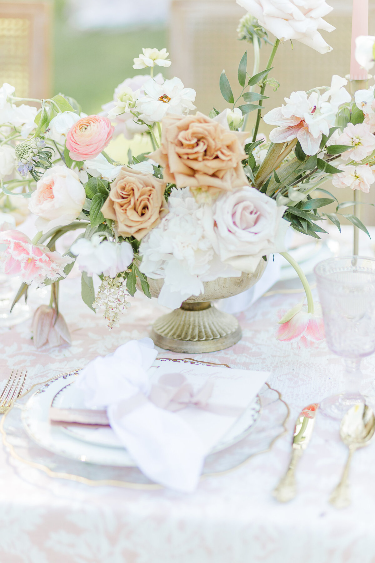 Detail image of table centrepieces featuring white, blush, and cream coloured flowers. Captured by best Massachusetts wedding photographer Lia Rose Weddings
