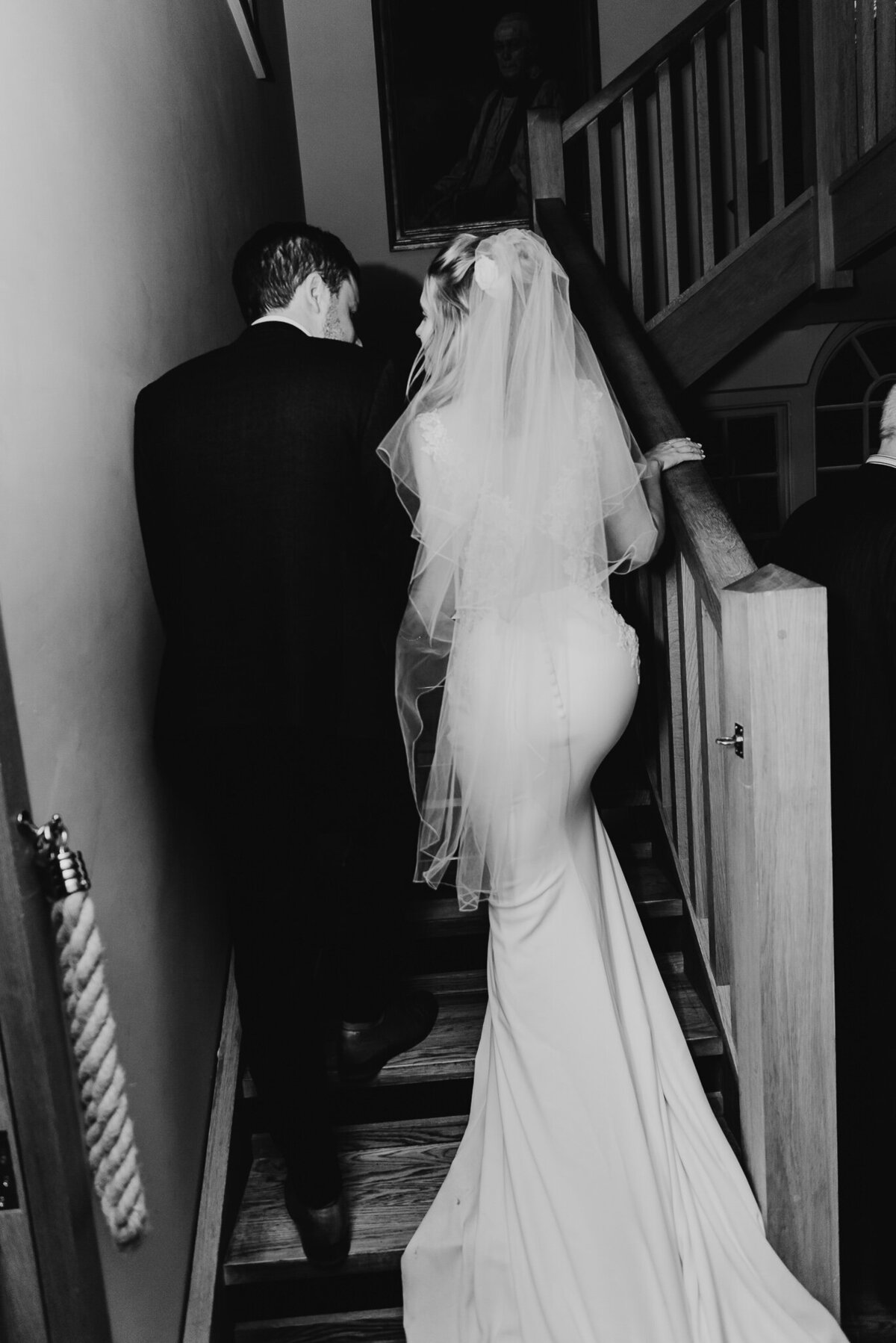 bride and groom black/white walking up the stairs