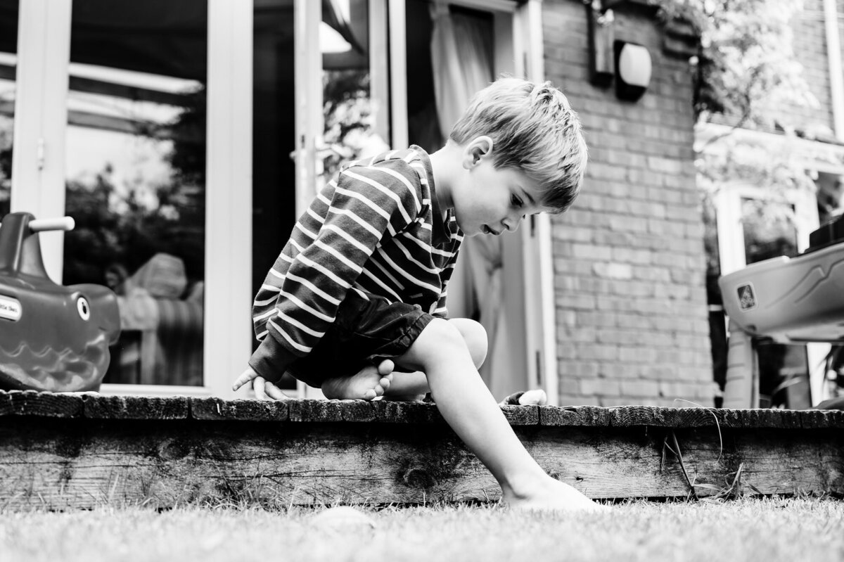 Little boy sat on the decking at home family photoshoot with amanda forman photography