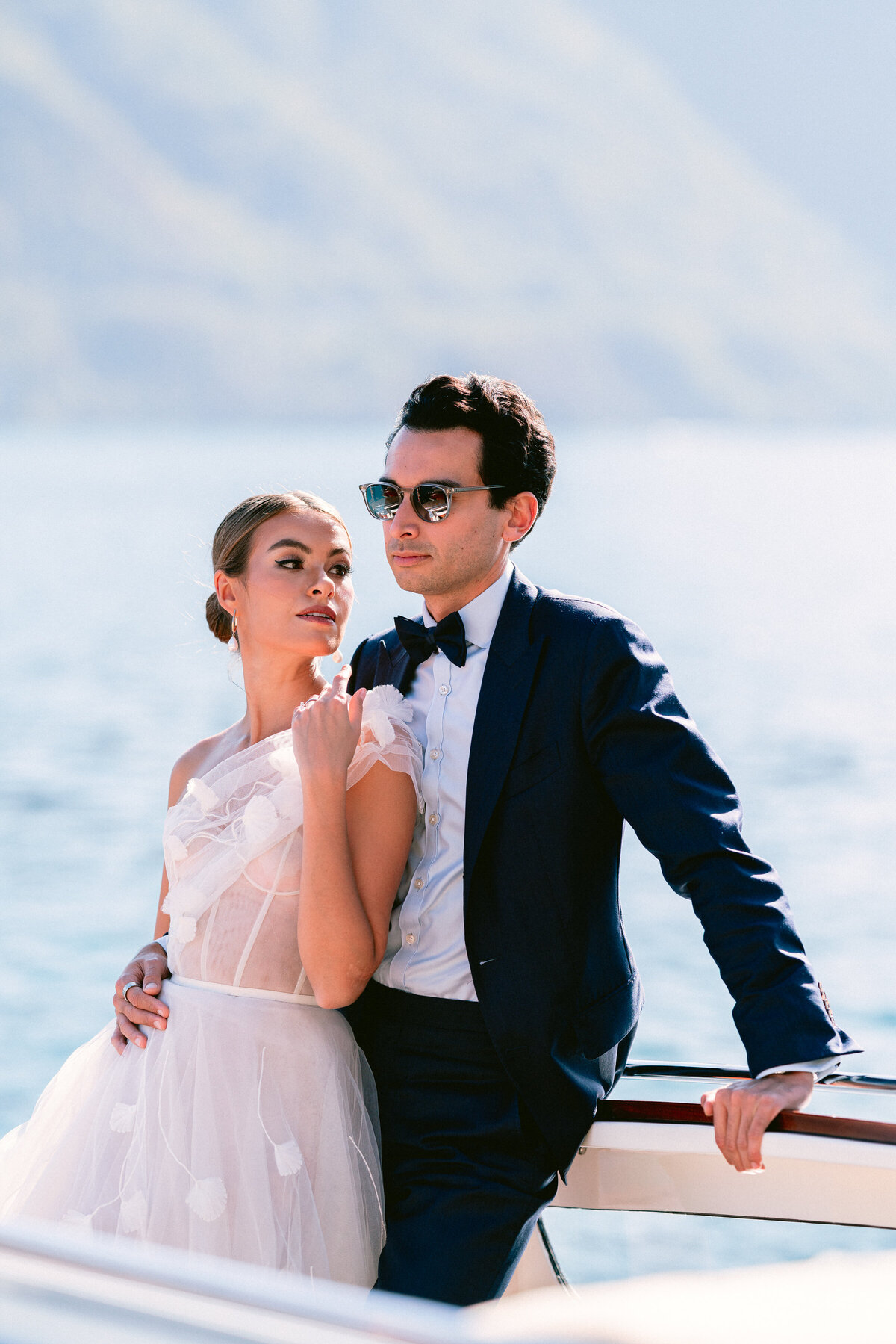 Bride and groom on board a private boat on lake como, italy