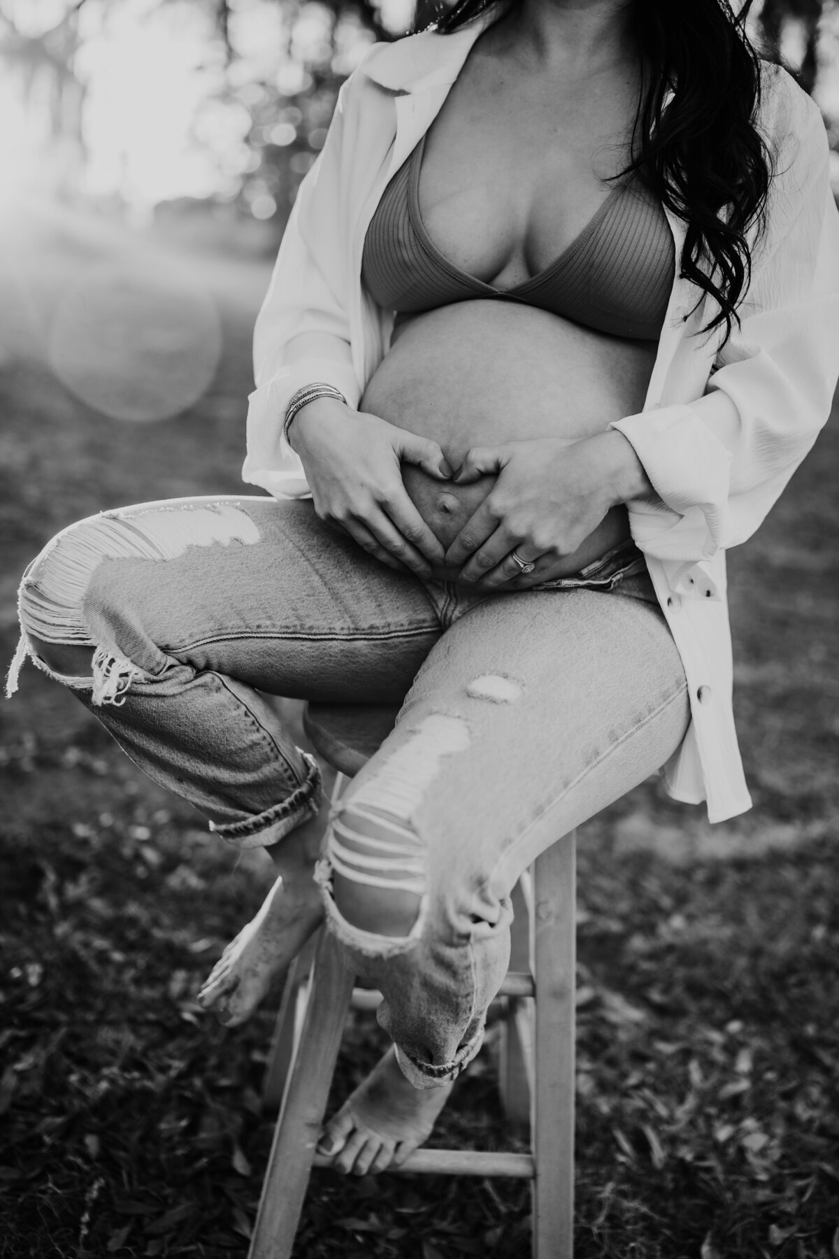 candid, casual, exposed belly pregnancy photo at sunset in Lafayette, la in black and white