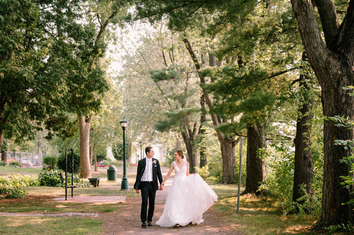 bride and groom walking in the woods
