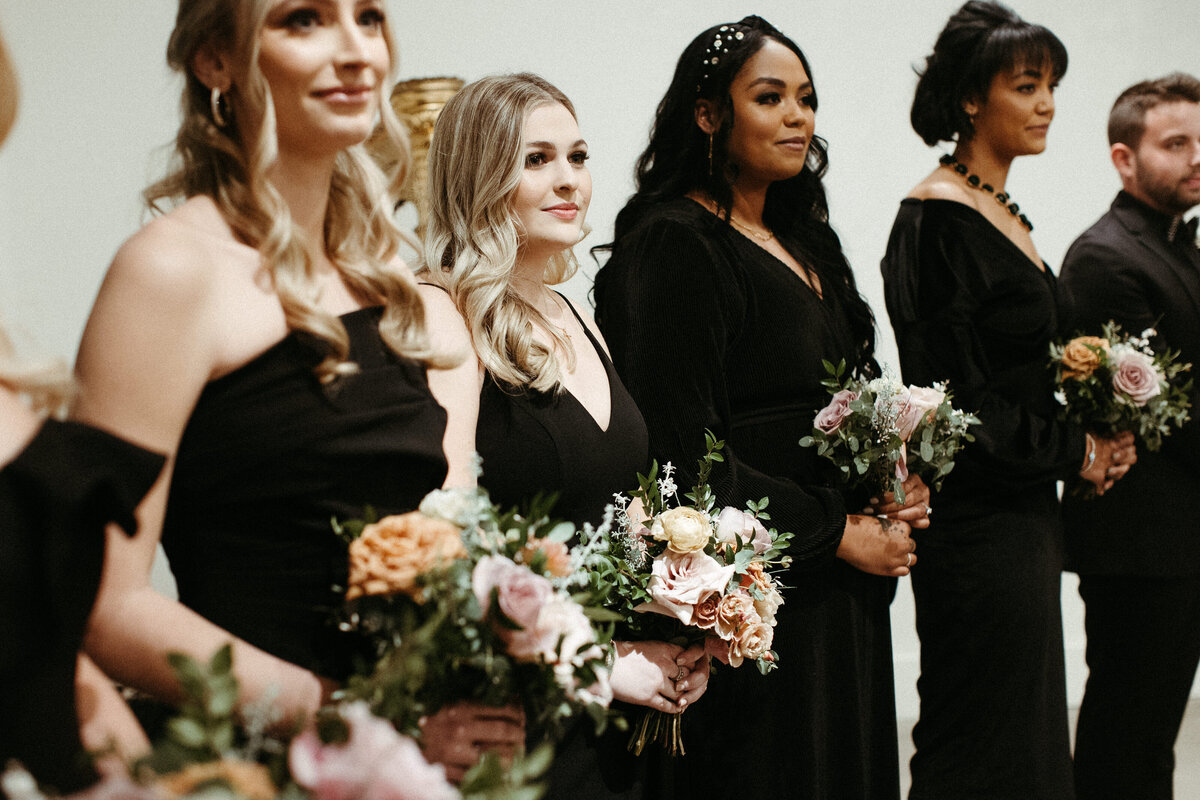 Beautiful bridal party bouquets brought warm hues of dusty pink, terra cotta, mauve, and burgundy. Art deco wedding florals comprised of roses, ranunculus, dried branches, and greenery. Designed by Rosemary and Finch in Nashville, TN.