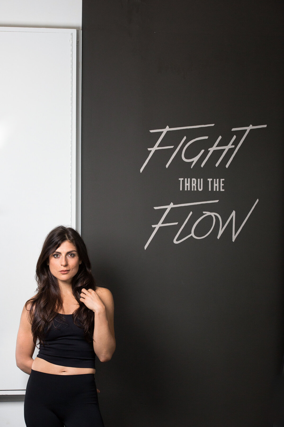 woman standing next to flight thru the flow sign