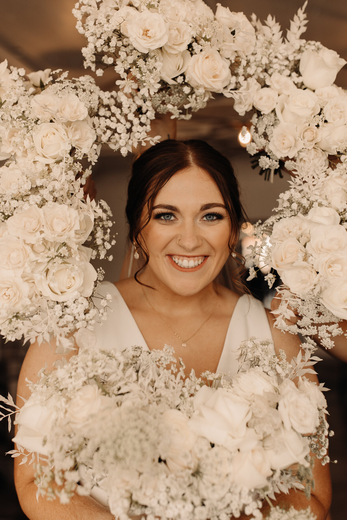 bride portrait with bouquets surrounding her face