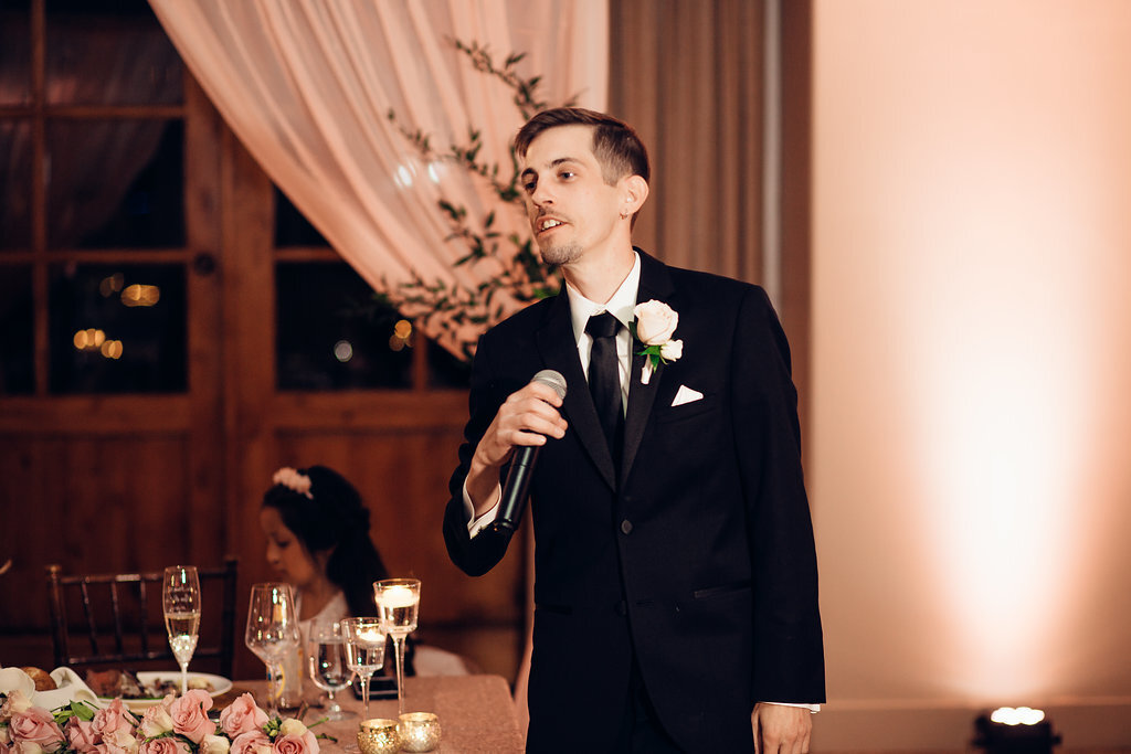 Wedding Photograph Of Groom In Black Suit Holding a Microphone Los Angeles