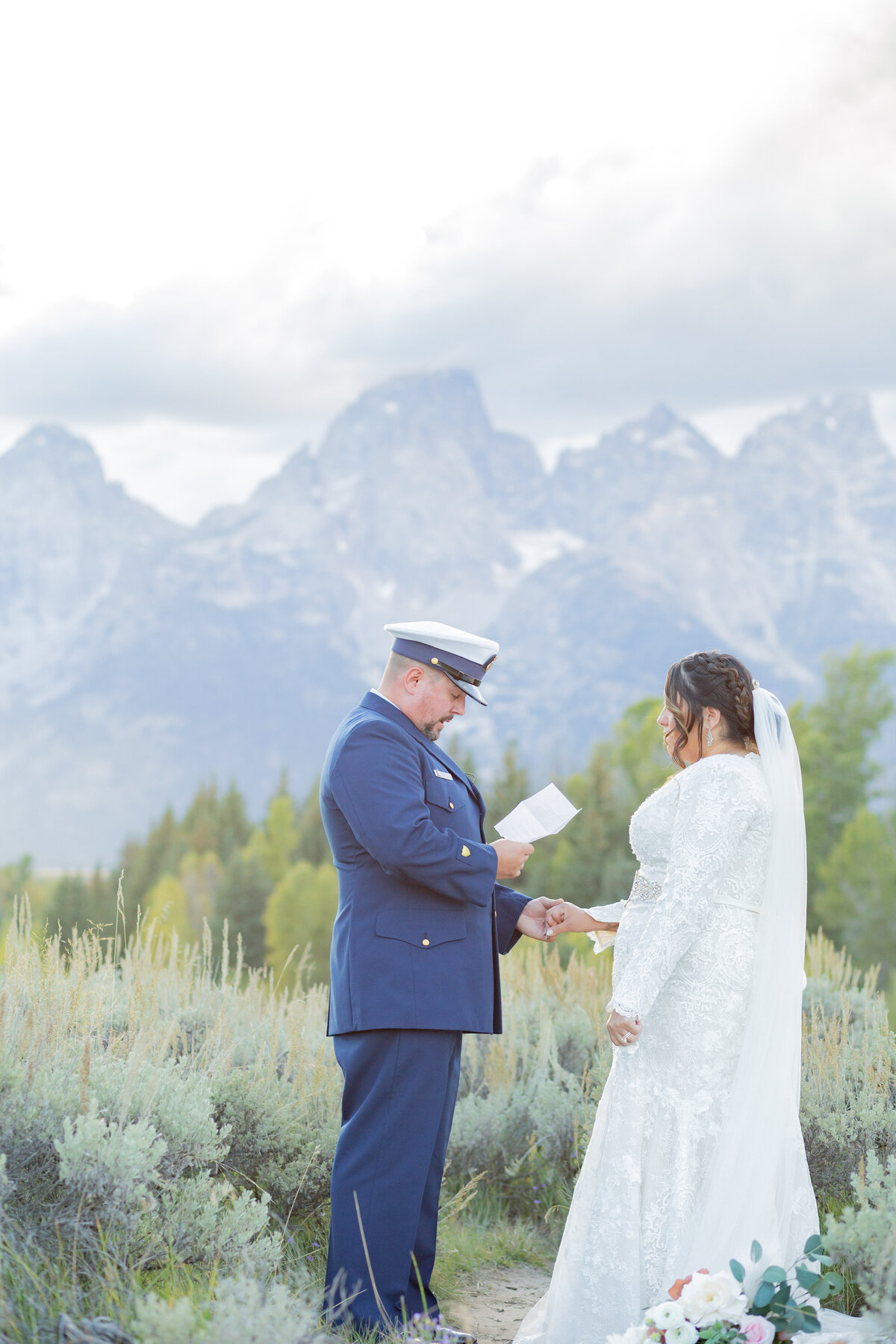 Washington Elopement photographer captures groom reading vows to bride during mountain elopement