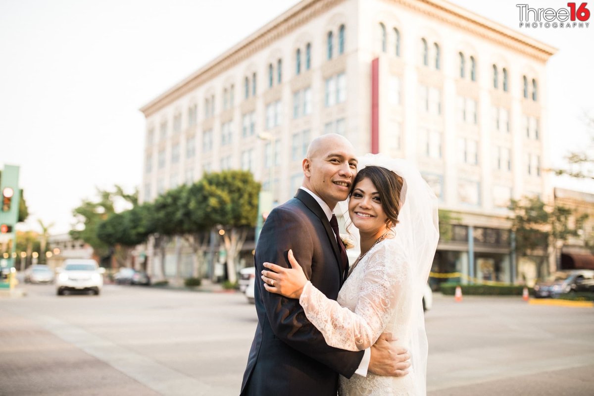 Bride and Groom pose for photo in the streets of downtown Fullerton