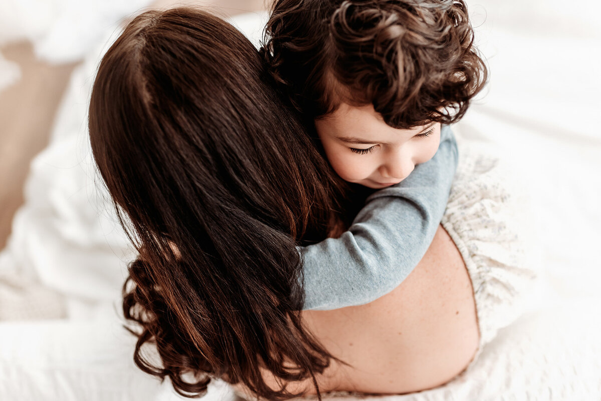 overhead view of son hugging mom by denver milestone photographer Alyssum Hutchison