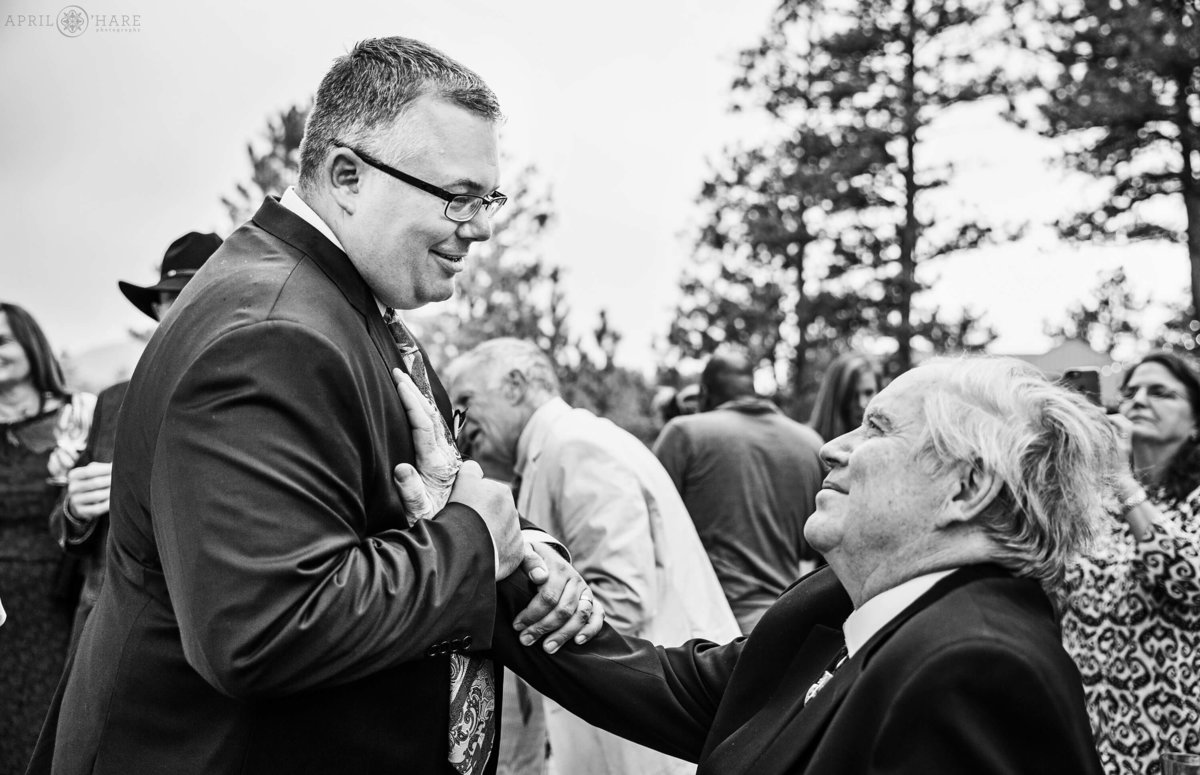Sweet Moment groom with father in law at a Colorado mountain wedding reception