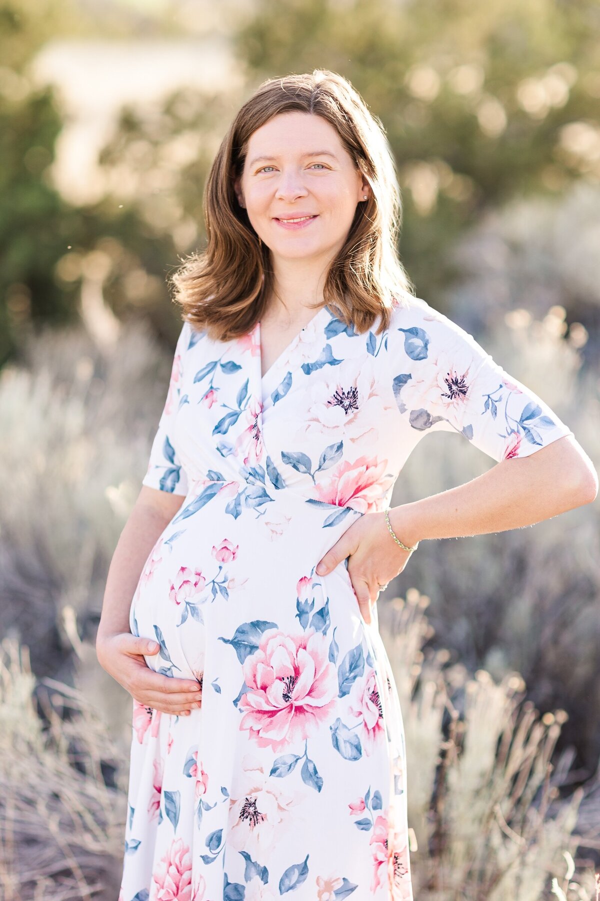 Expectant mama holding her baby bump with Erin Thompson Photography