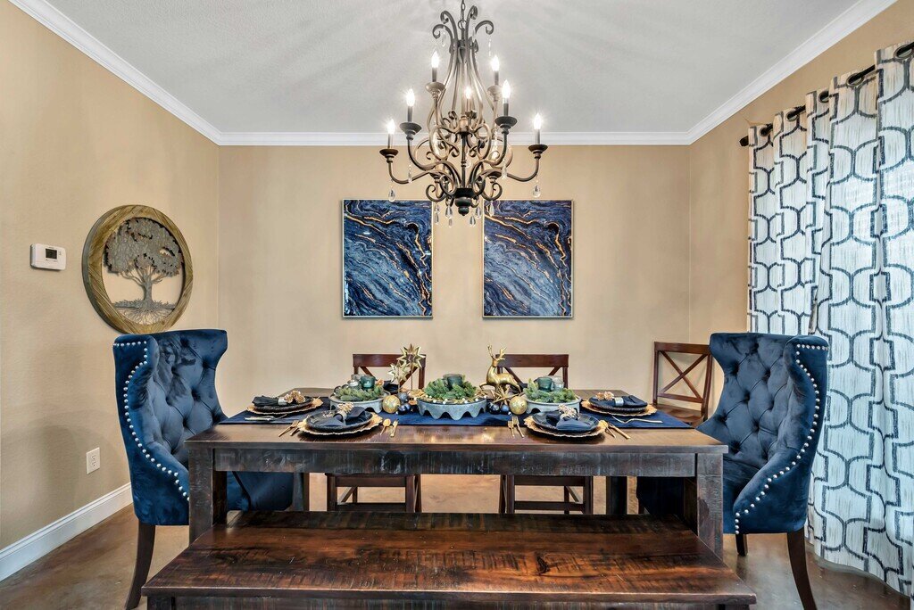 Dining room with seating for 8 in this four-bedroom, four-bathroom vacation rental home and guest house with free WiFi, fully equipped kitchen, firepit and room for 10 in Waco, TX.