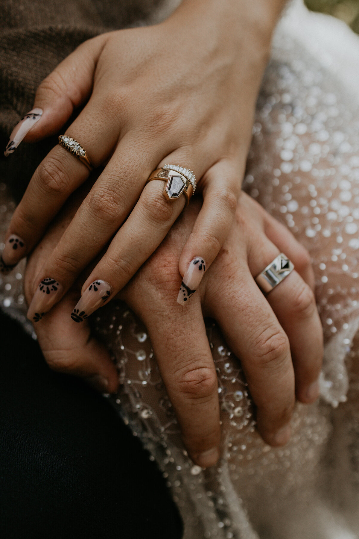 brides and groom hands with alternative wedding rings up close