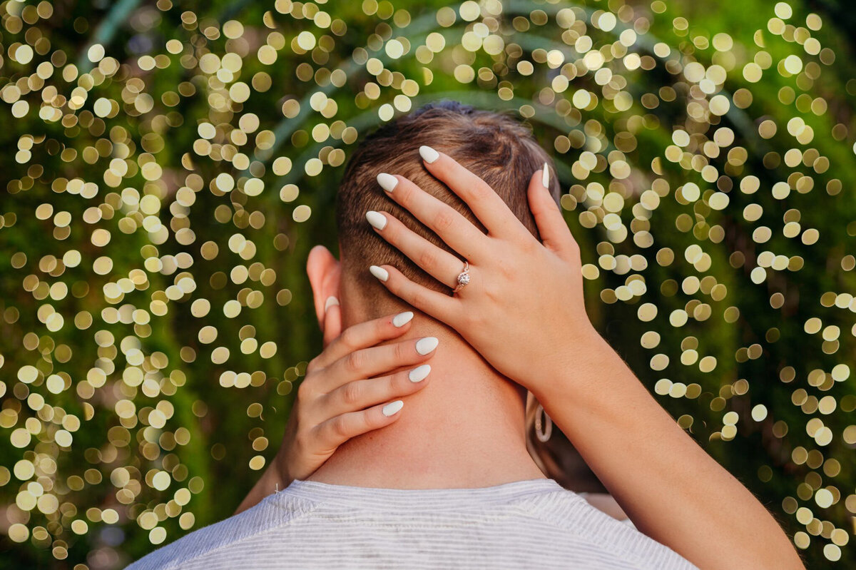 photo of a woman's hands hugging a man's head