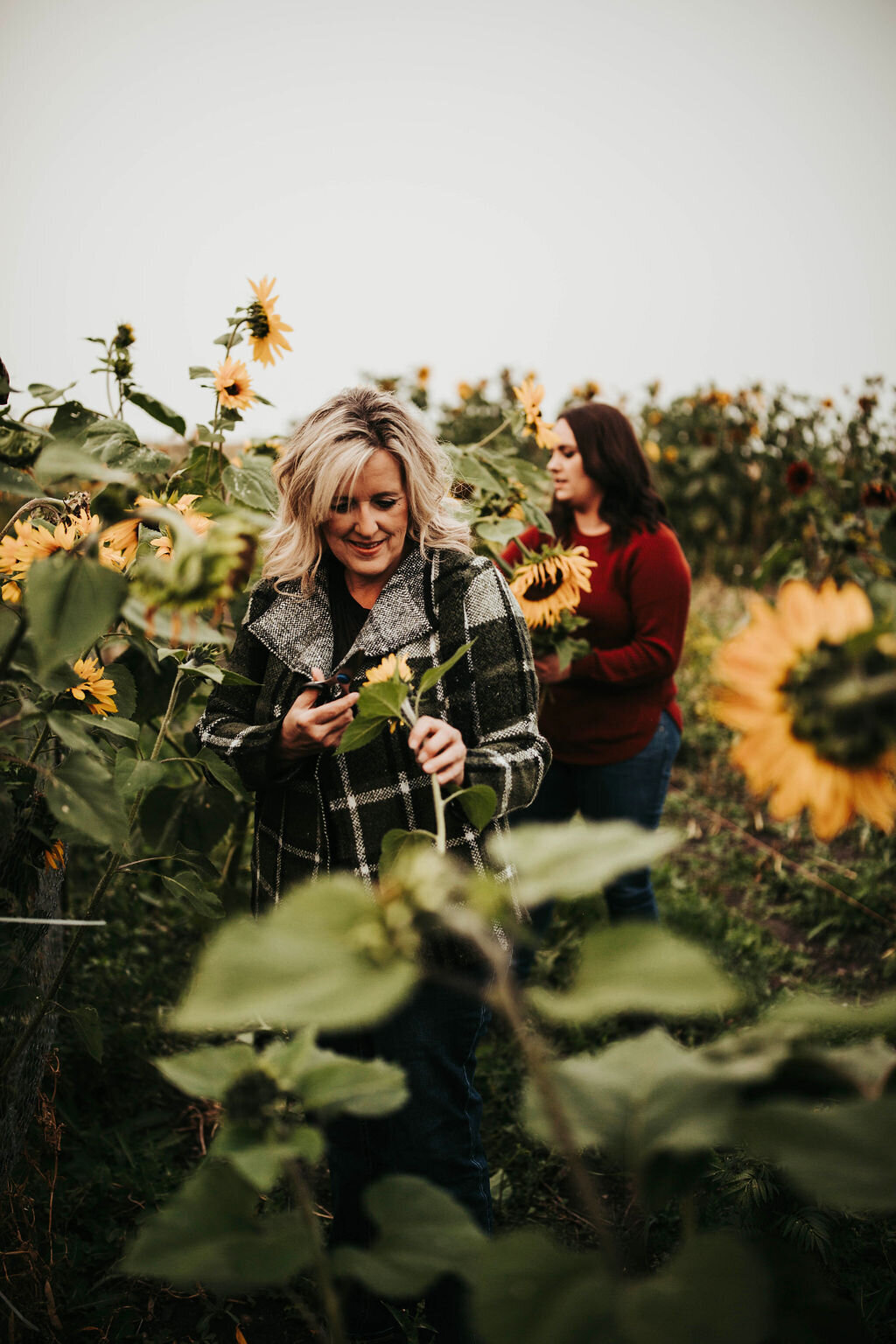 two women in a sunflower garden