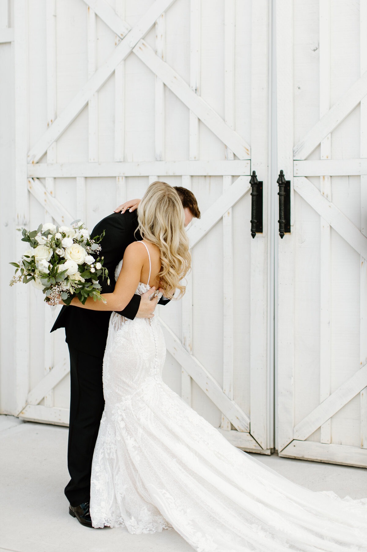 Bride and Groom hugging during first look outside of White Dove Barn