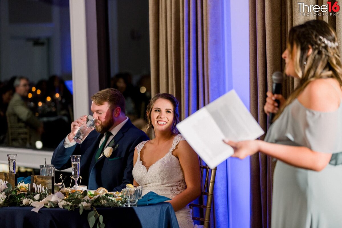 Bridesmaid toasts the Bride and Groom