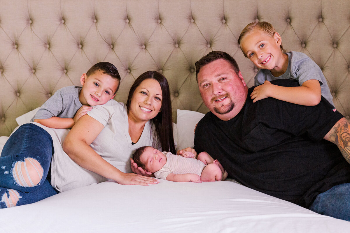 family surrounds new baby
