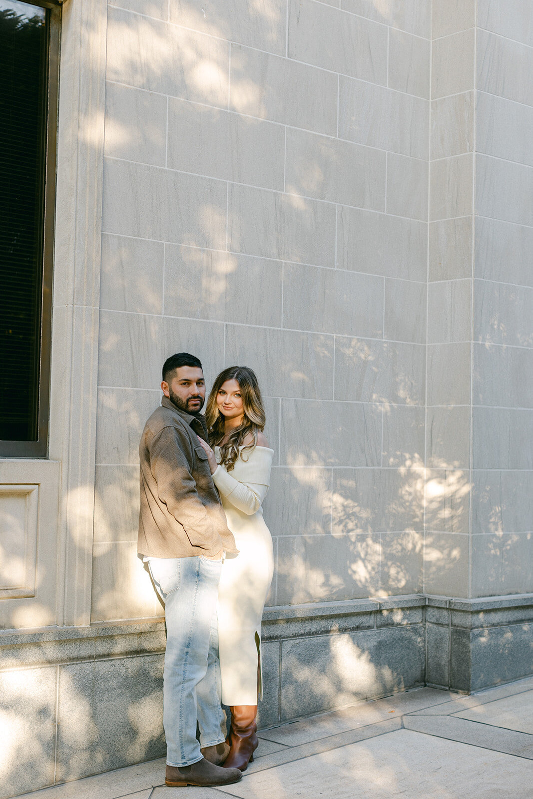 Couple embracing during golden hour engagement session in a Pittsburgh park