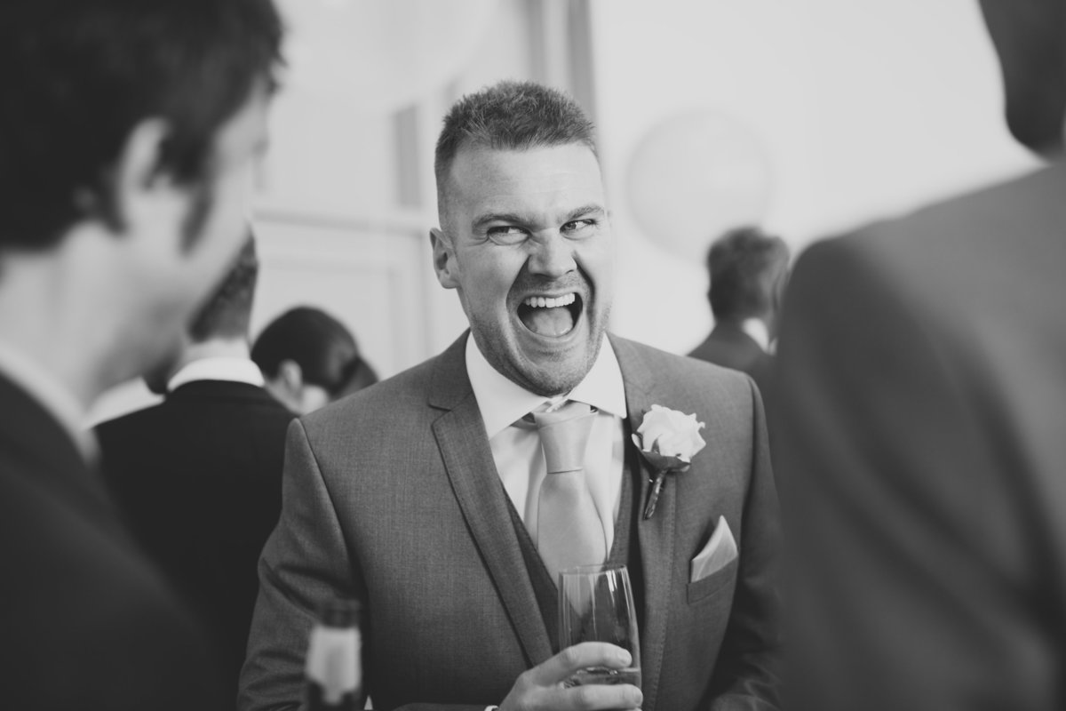 best man laughing talking with friends