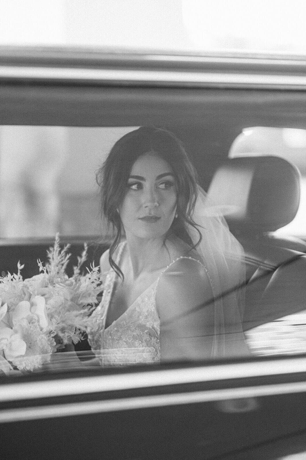 bride-in-car-with-flower-bouquet