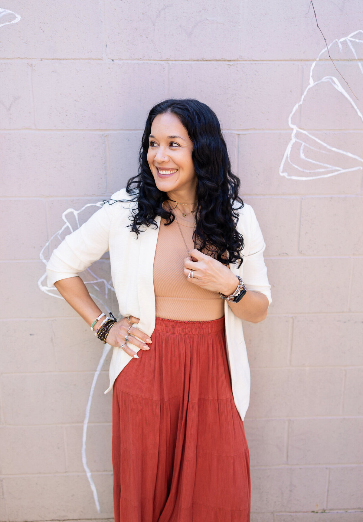 woman-holds-necklace-during-personal-brand-headshots-in-baltimore-maryland-during-her-brand-photoshoot