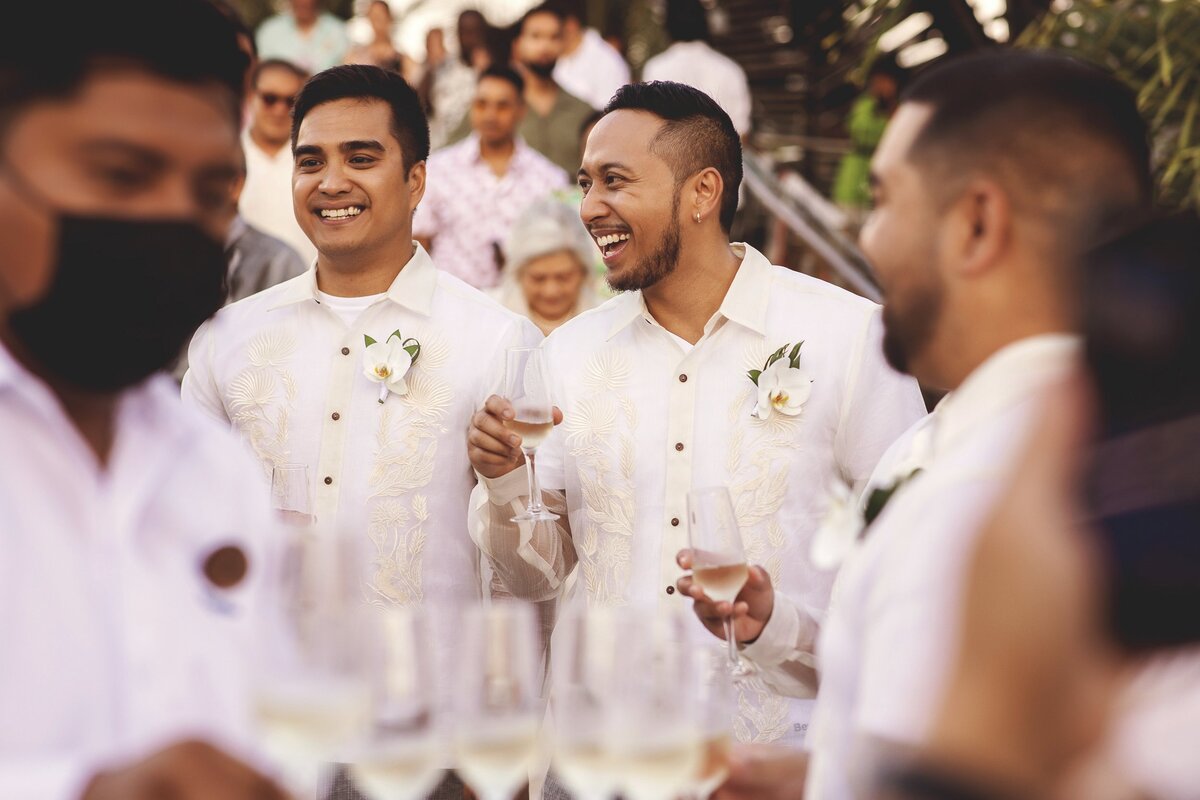 Groomsmen laughing and celebrating after wedding ceremony in Cancun