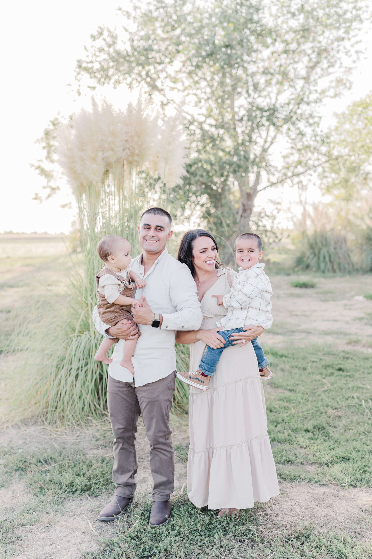 family laughing in the park at sunset by Caroline Bendel, Sacramento Family Photographer