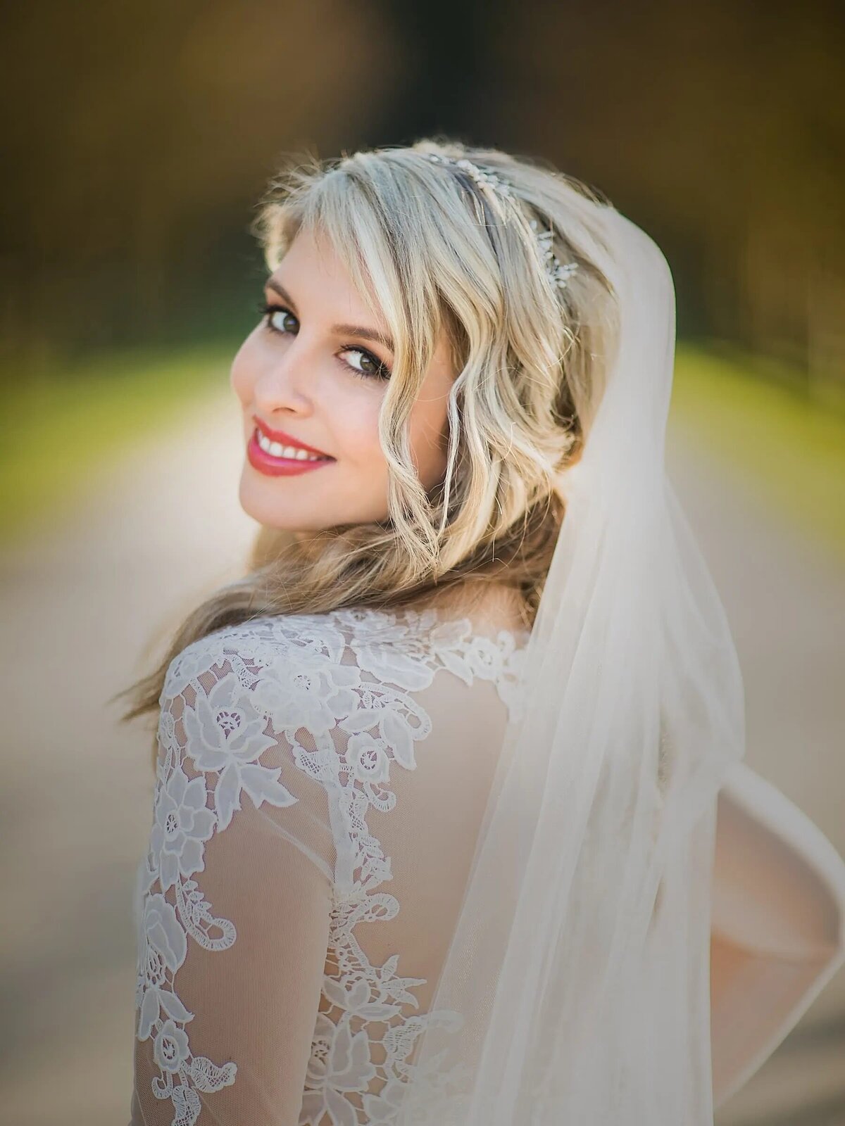 A bride smiling and looking back over her shoulders