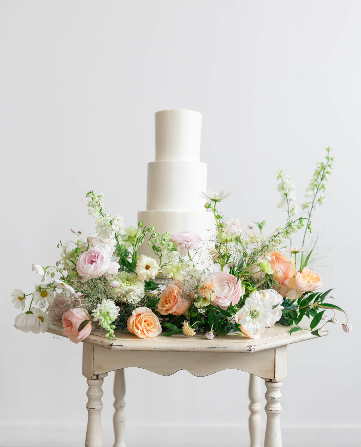 wedding cake surrounded by flowers