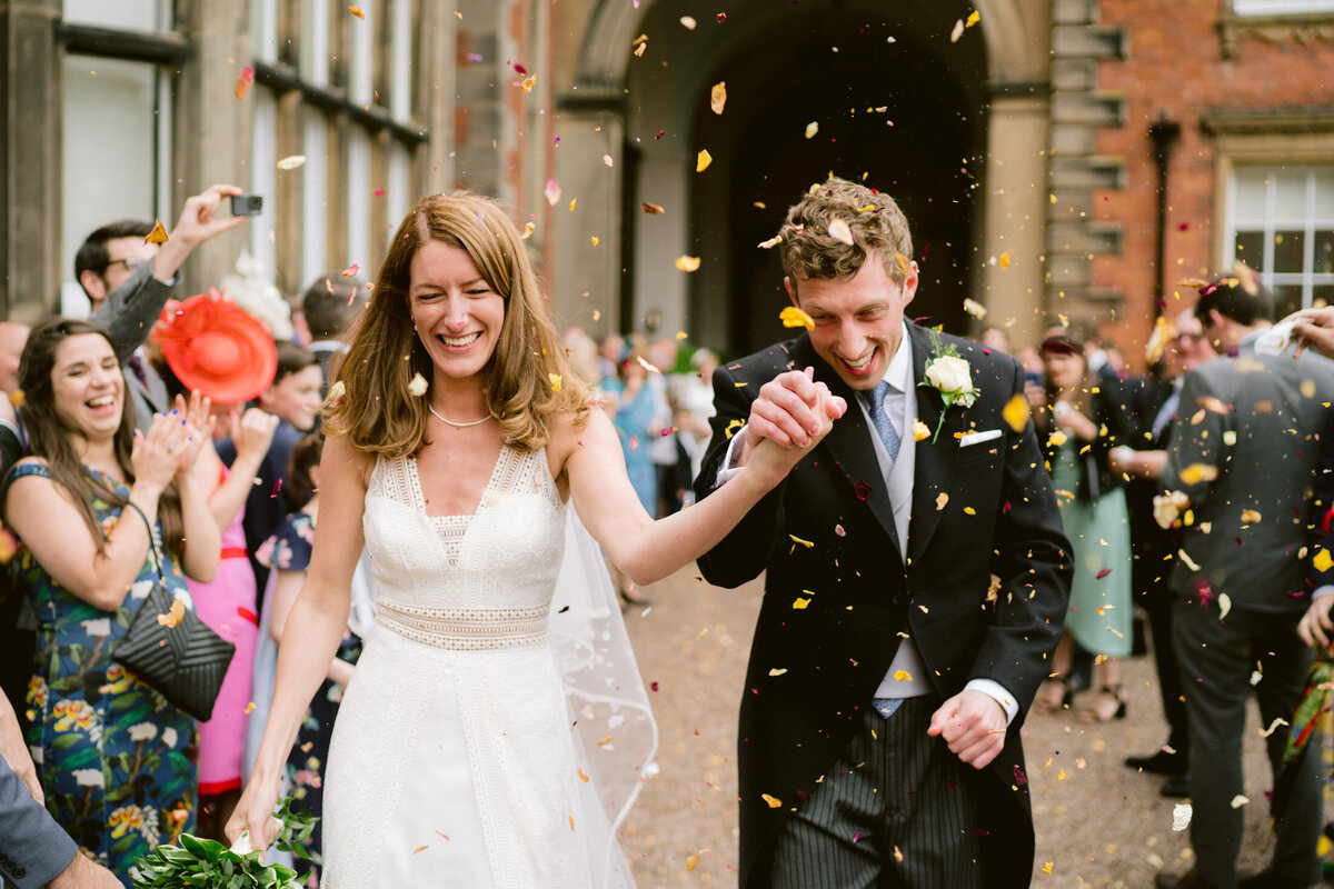 confetti being thrown at the couple at capesthorne hall