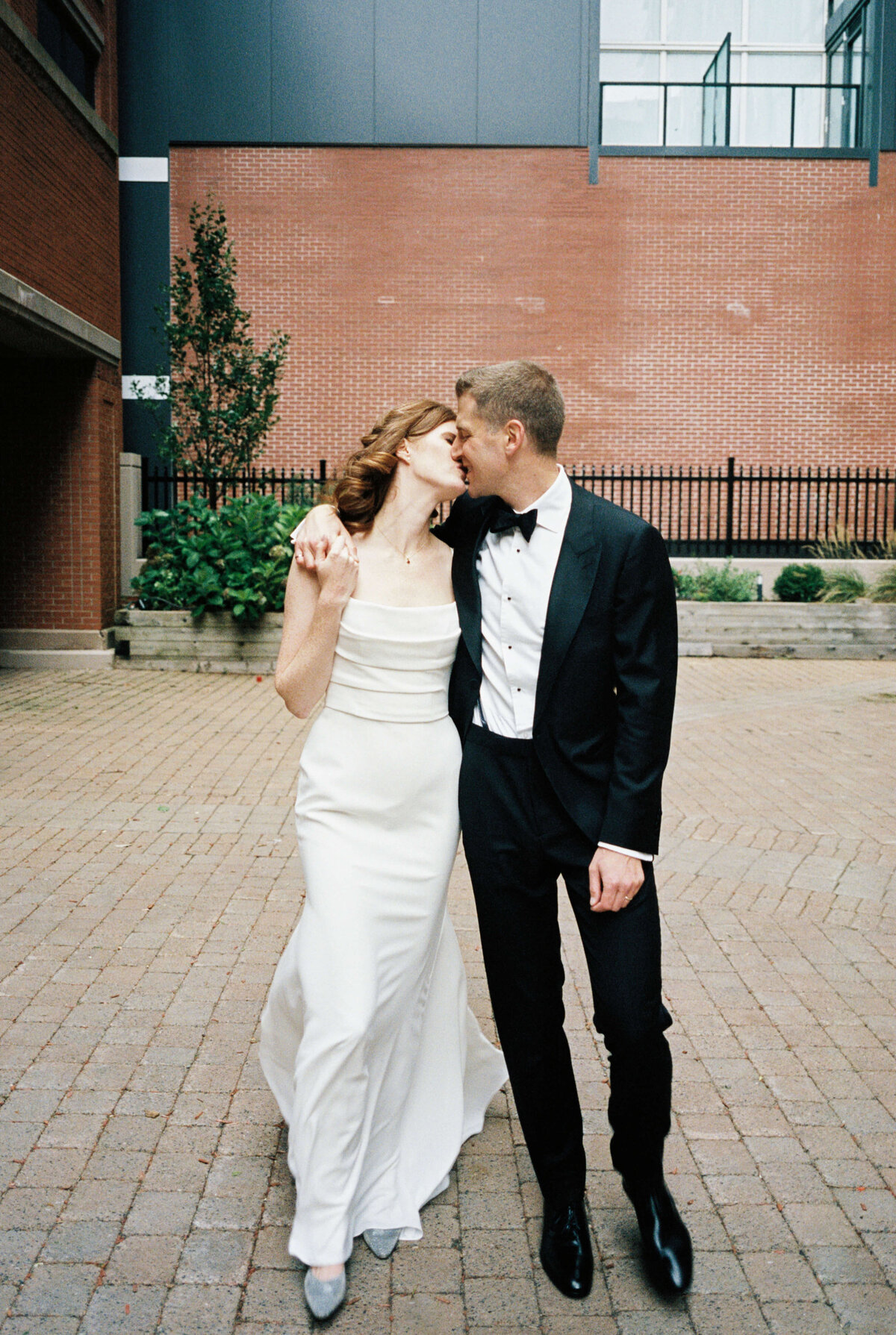 Bride and groom kissing outside the Lord Nelson Hotel, Halifax, Nova Scotia