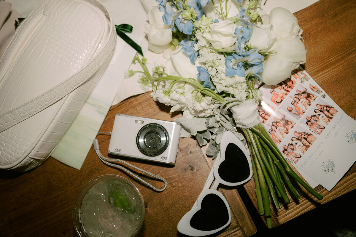 Photo booth accessories for a summer wedding in Jackson, WY, featuring elegant props like sunglasses, playful mustaches on sticks, and floral crowns.