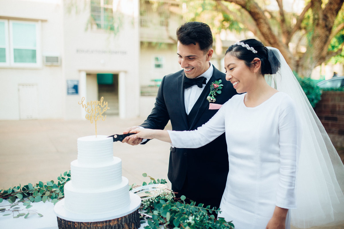 Couple Cutting Wedding Cake In California