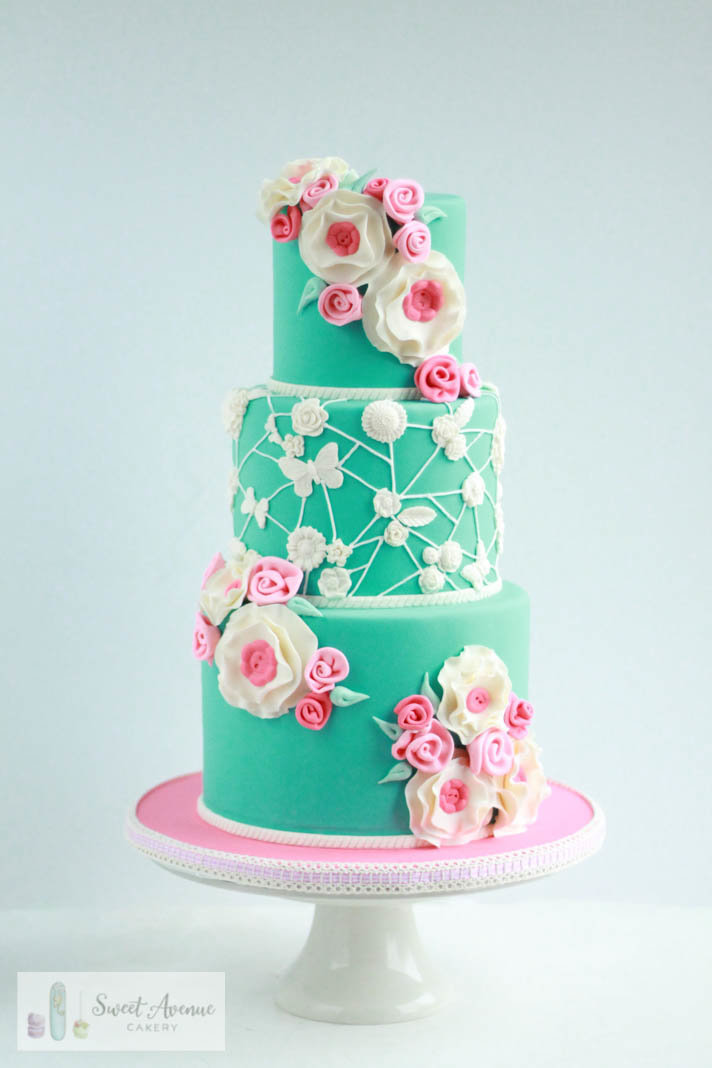 pink and teal cake with flowers