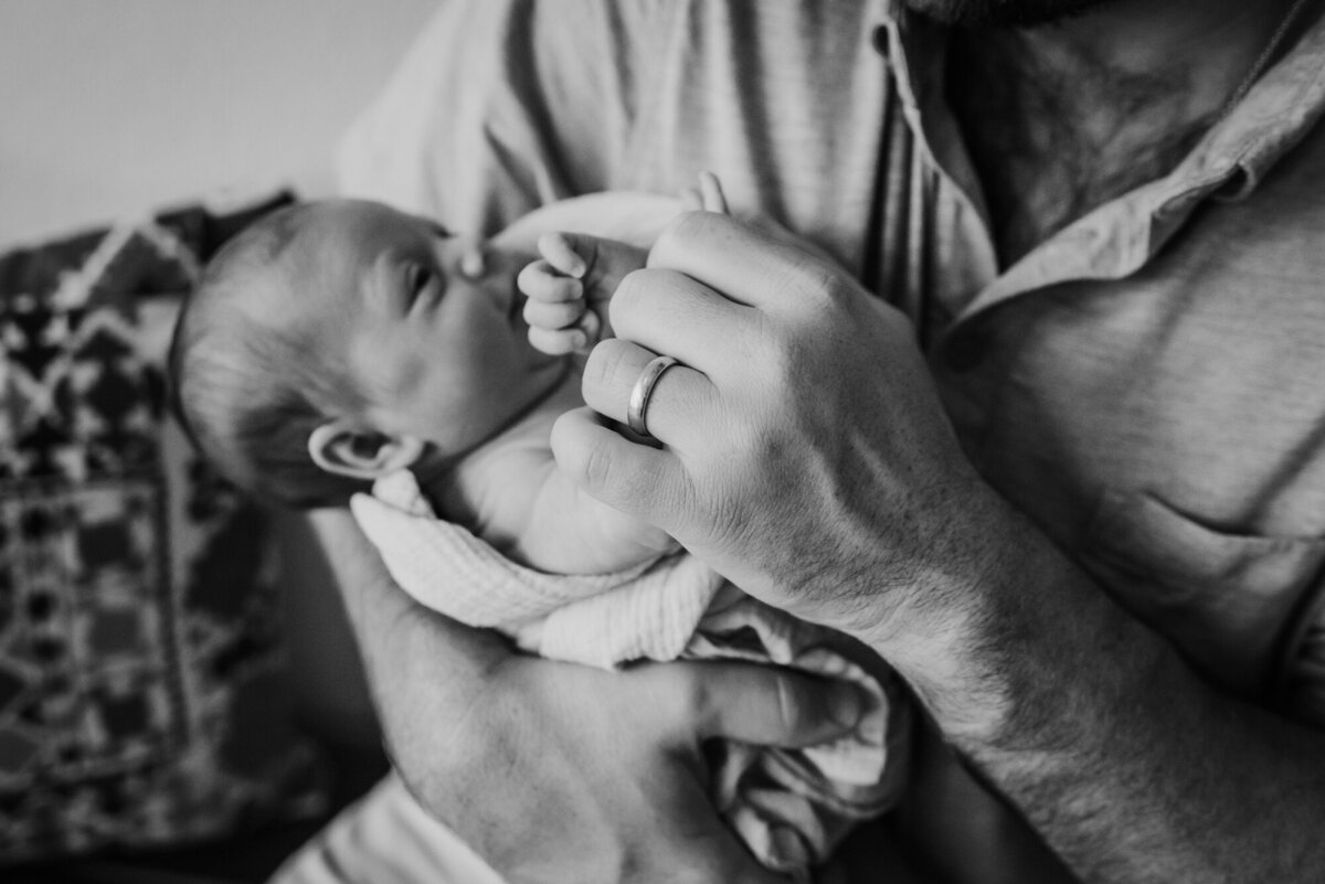 Newborn Photography, Dad holding baby in his arms.