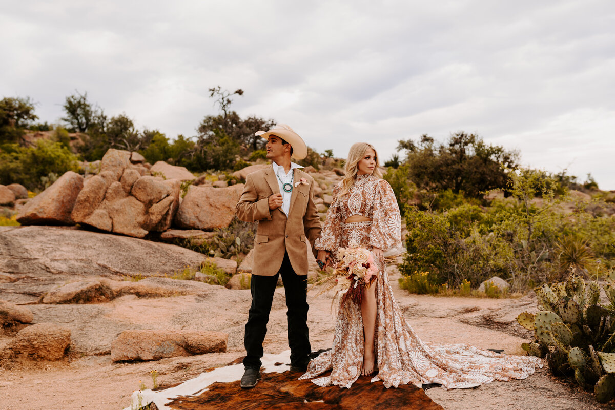 bride and groom hold hands at enchanted rock
