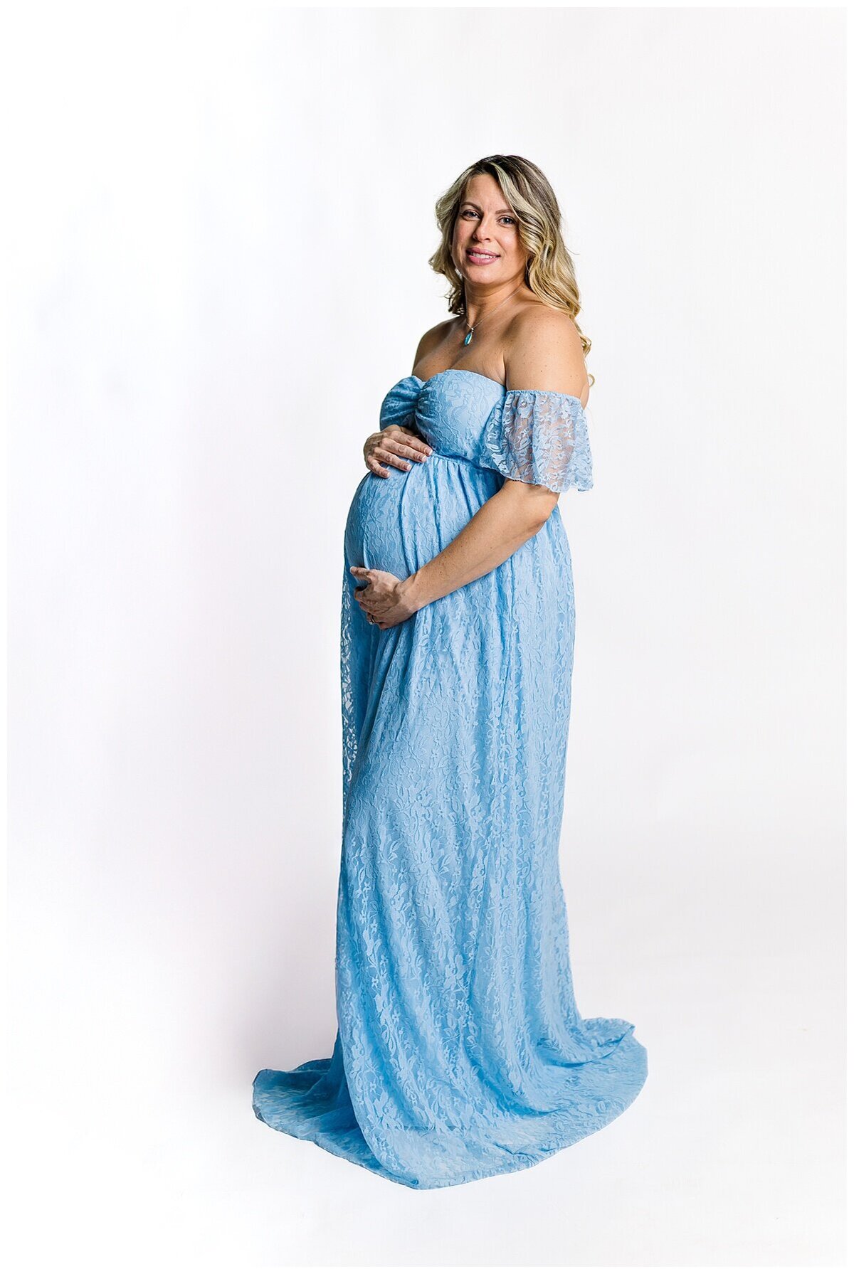 Mom to be showing off her beautiful baby bump in a blue dress during a maternity photoshoot in studio in Wexford PA