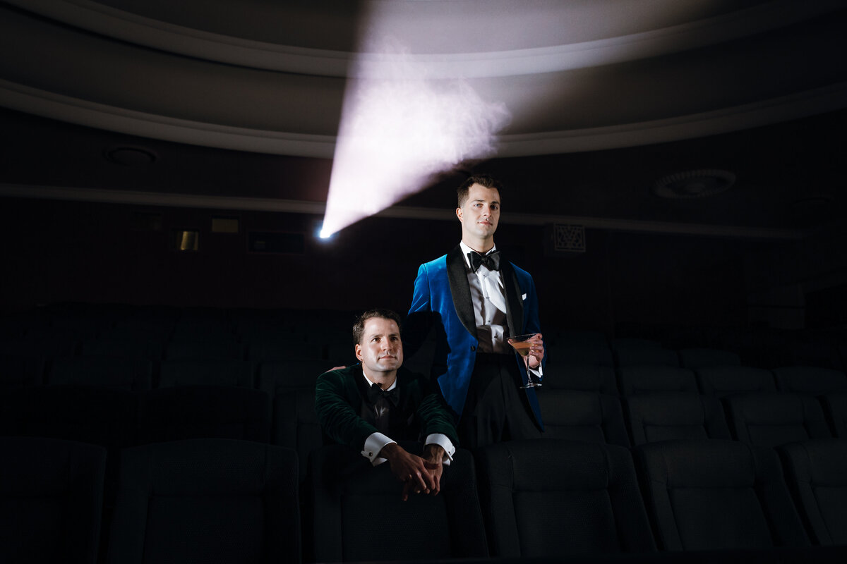 Two grooms pose for camera before their Cinema wedding.